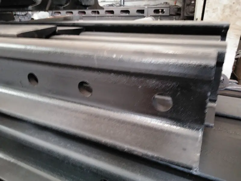 Railway rail web hole punching