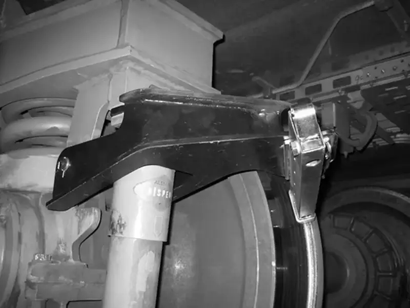 Wheel flange lubricator mounted on crane wheel