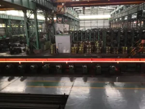 Rolling mill workshop used in rail manufacturing, shaping heated billets into precise rail profiles.