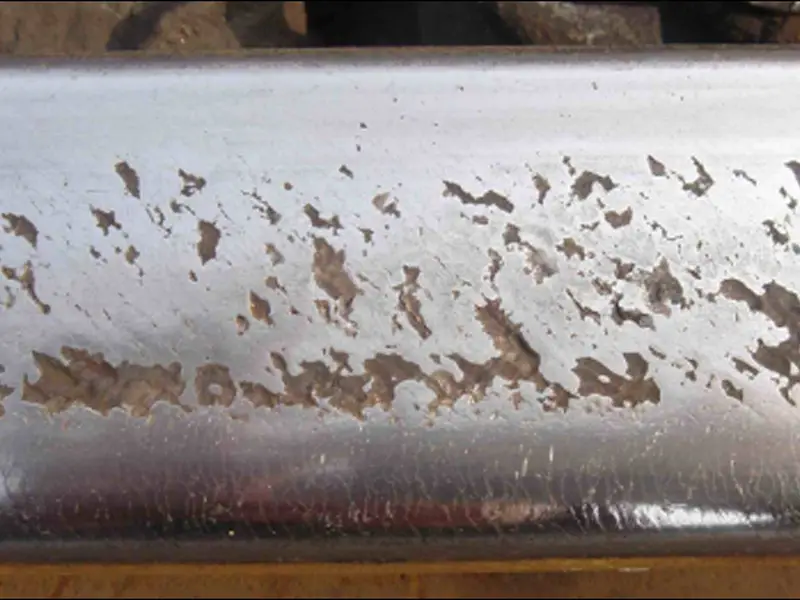 Rail spalling showing fish-scale pattern damage on the rail head surface