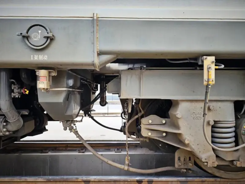 Close-up of train wheel on rail showing contact area related to train sanding system and traction performance