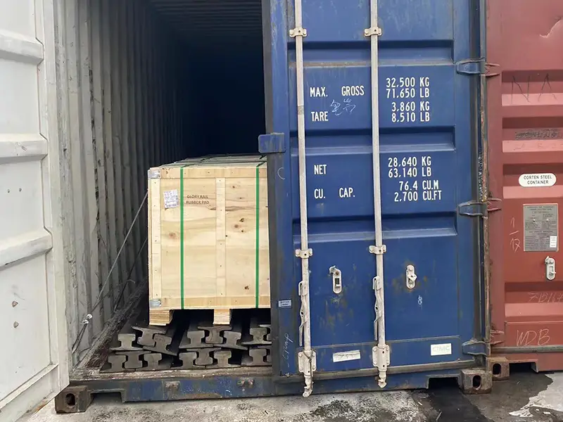 A100 crane rails and rubber rail pads secured in a shipping container for delivery to Jakarta
