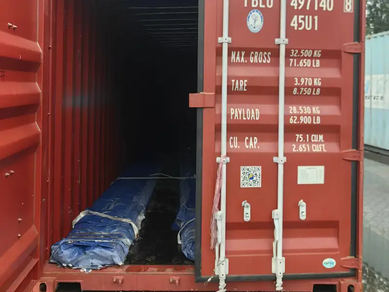 A100 rail bundles wrapped with blue VCI anti-rust film and secured with steel strapping.