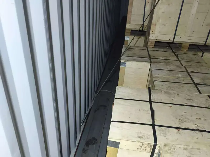 CR73 crane rail secured with steel straps and wooden supports inside container