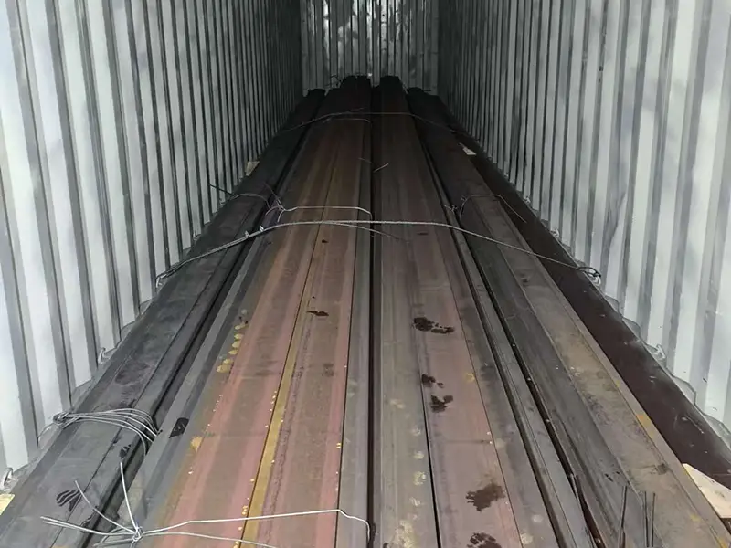 Close-up view of crane rails secured near the container entrance