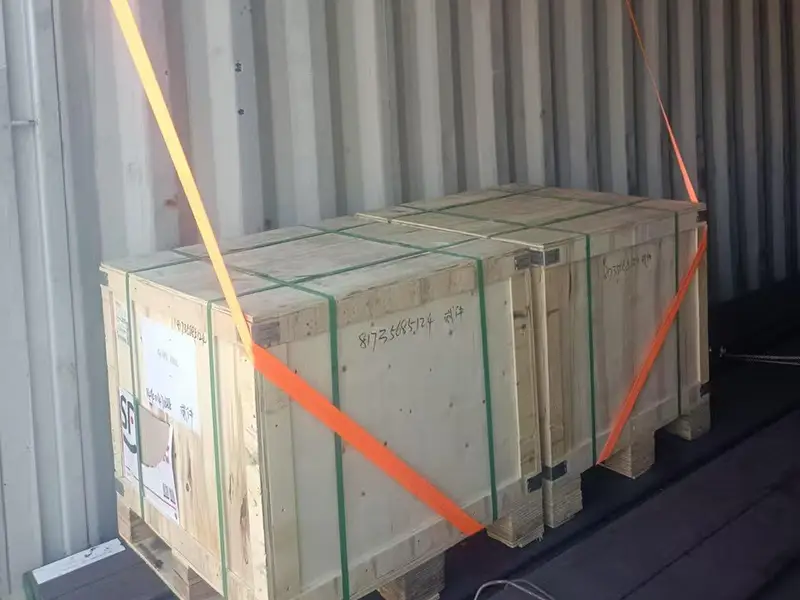 Close-up view of rails and wooden box secured inside container