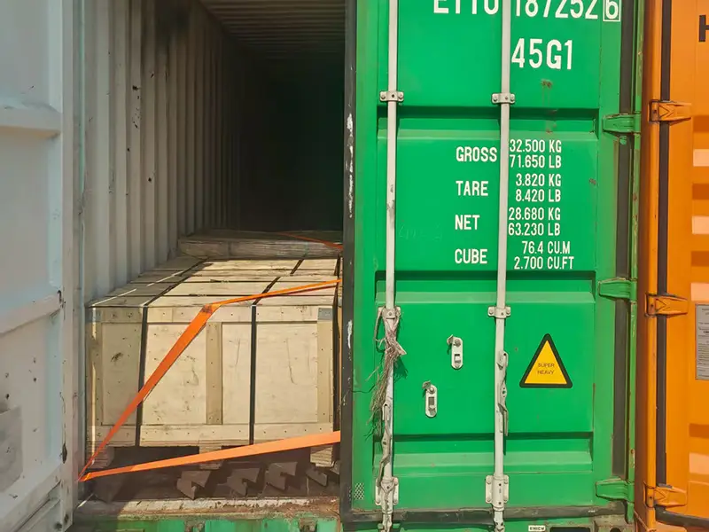 Rail bundles positioned and secured inside the container to help minimize movement during sea transportation.