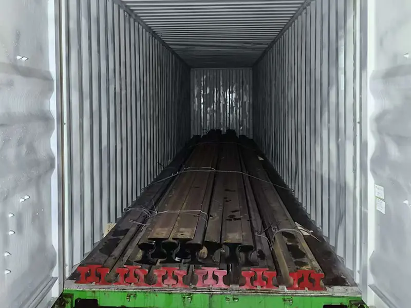 Steel rails secured inside a shipping container for export delivery