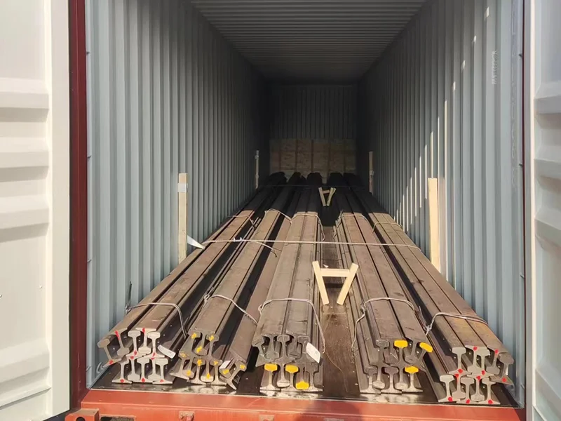 Steel rail bundles secured with timber dunnage and straps